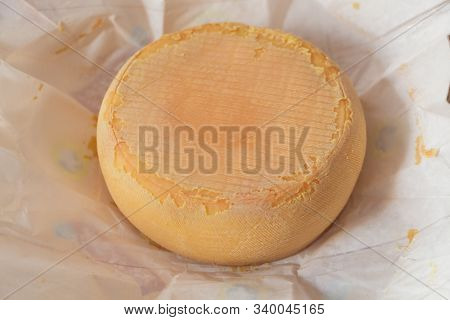 Orange Melzer Cheese In Open Paper Packaging