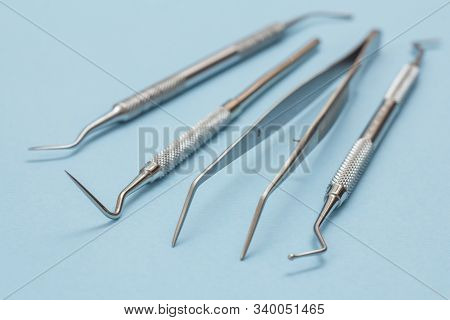Set Of Metal Dental Instruments For Dental Treatment. Dental Plugger, Tweezers, Probe And Scraper On