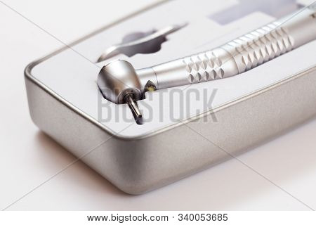 High-speed Dental Handpiece In Packing Box On White Background. Dental Instruments For Dental Treatm
