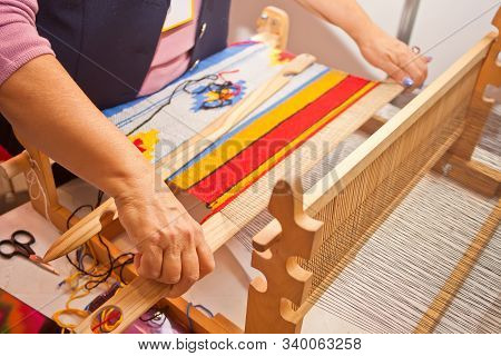Woman Hand Weave On The Weaving Machine