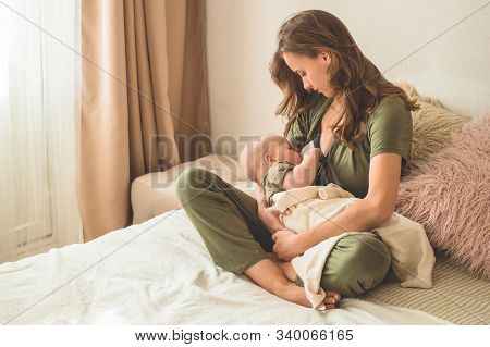The Concept Of Breastfeeding. Portrait Of Mom And Breastfeeding Baby.