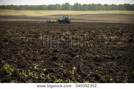 Tractors Plow Plowland On An Autumn Clear Day