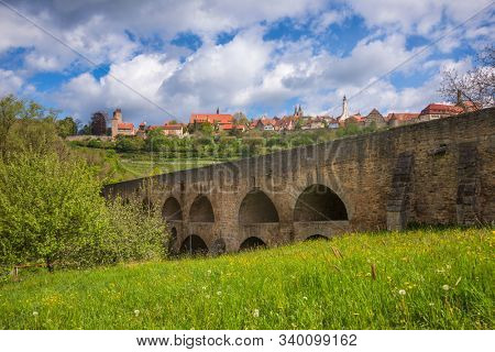 Medieval stone double bridge over Tauber at Rothenburg ob der Tauber, Bavaria, Germany, Europe, one of the most popular travel destination on Romantic Road touristic route