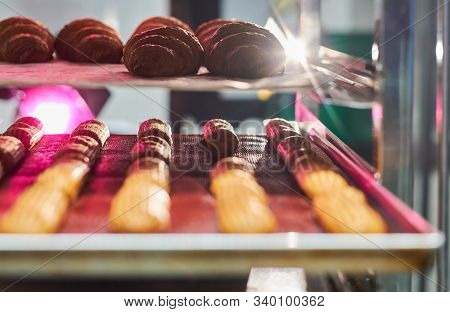 Fresh Cookies With Chocolate Are Ready To Be Removed From The Oven At Bakery Shop.