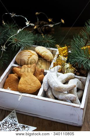 Assorted Christmas Cookies And Christmas Decorations In A Wooden Box On A Wooden Background. Rustic 