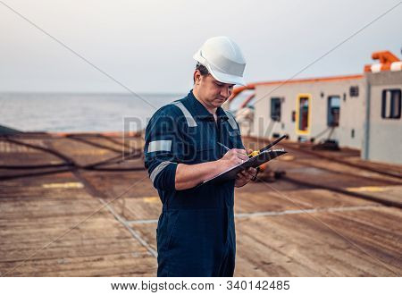 Deck Officer On Deck Of Offshore Vessel Or Ship , Wearing Ppe Personal Protective Equipment. He Fill