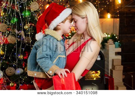 Little Santa Give A Hug To Sister. Brother And Sister Celebrate Christmas Or New Year. Hug And Embra