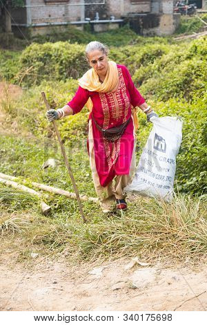 Mayapur, West Bengal, India - Dec 14, 2019. Female Volunteer Collects Garbage In India With Recycle 