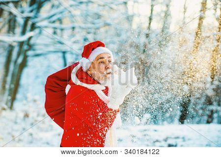 Santa Blowing Snow. Merry Christmas And Happy Holidays