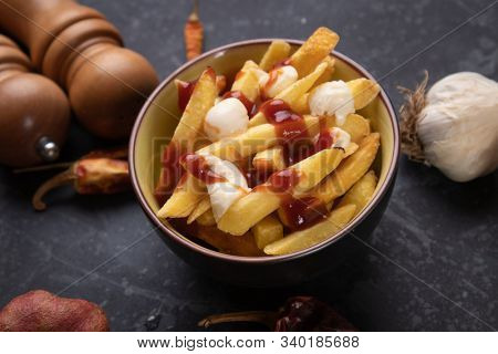 Canadian poutine, fried potato chips with cheese and gravy or sauce