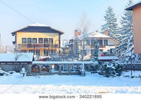 Bansko, Bulgaria - December 5, 2019: Street View, Traditional Houses And El Torito Restaurant In Bul