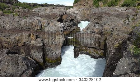 View Of The Barnafoss Waterfall, In Borgarfjordur, Western Iceland. Panoramic View Of Icelandic Land