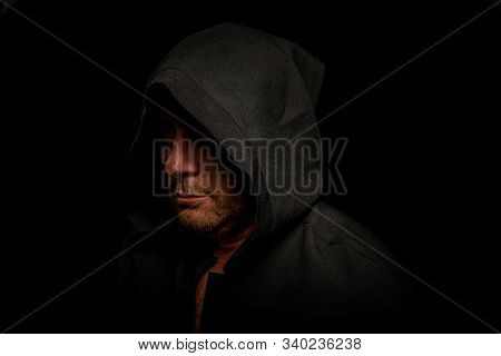 Portrait Of A Courageous Warrior Wanderer In A Black Cloak. Historical Fantasy. Halloween