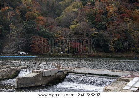 Kyoto, Japan-26 Nov, 2019: Katsuragawa River With Colourful Forest Mountain Background In Arashiyama