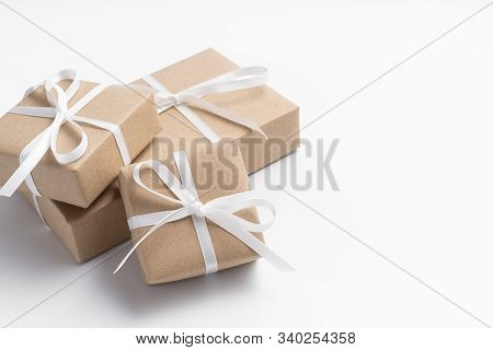 Brown Gift Box Tied With White Ribbon On Clear Background, Copy Space, Eco-friendly Present Concept