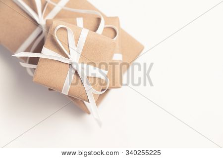 Brown Gift Box Tied With White Ribbon On Clear Background, Copy Space, Eco-friendly Present Concept
