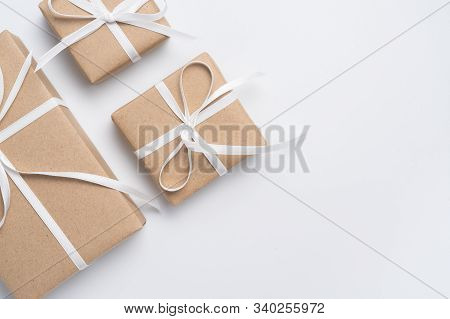 Brown Gift Box Tied With White Ribbon On Clear Background, Copy Space, Eco-friendly Present Concept