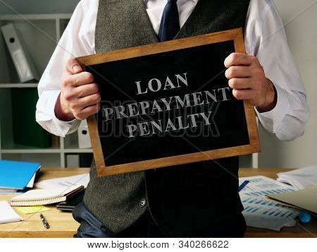 Loan Prepayment Penalty Concept. Man Is Holding Blackboard.