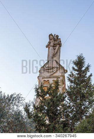 Jerusalem, Israel, December 07, 2019 : Statue Of The Mother Of God With A Baby In Her Arms On The Ro