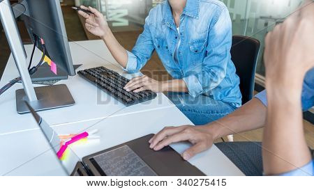 Young Startup Programmers Sitting At Desks Working On Computers Screen For Developing Programming An