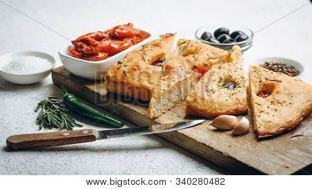 Traditional Italian Focaccia With Tomatoes, Olives And Rosemary - Homemade Flat Bread Focaccia.