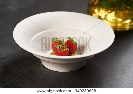 Fresh Peeled Chili Tomatoes And Minced Cucumbers On Dark Background