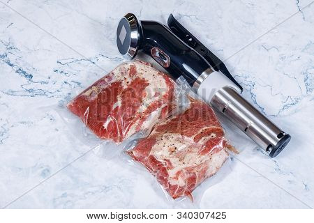 Sous Vide Immersion Circulator Cooker And The Mea On A Light Background.