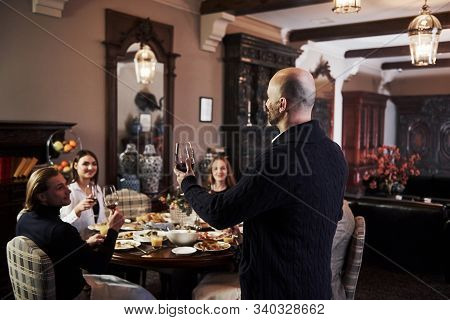 Listen To Me Please. Family Friends Having Nice Time In Beautiful Luxury Modern Restaurant.