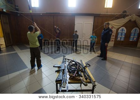 NIKOLSKY, RUSSIA - JAN 19, 2018: Training of children to use weapons in the framework of revival program of the Cossacks in the Leningrad region. Cossacks in St.Petersburg began its revival in 1990.