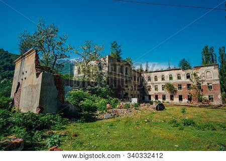 Ruined Overgrown School In Ghost Mining Town Akarmara, Consequences Of War In Abkhazia, Green Post-a