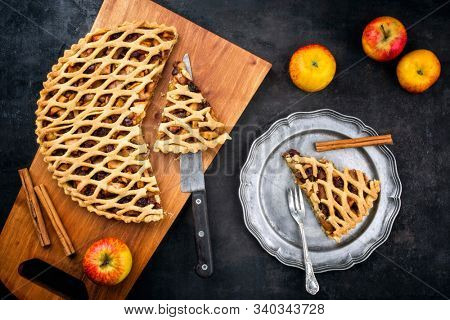 Traditional apple jalousie cake offered as top view on a modern design wooden board and pewter plate 