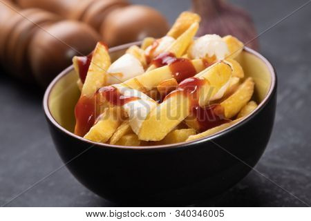 Canadian poutine, fried potato chips with cheese and gravy or sauce