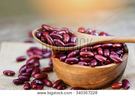 Red Bean In Wooden Bowl And Spoon On Sack Background / Grains Red Kidney Beans