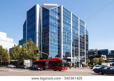 Sydney, Australia - March 27th 2013: Bus And Cars Passing Through A Junction With A Large Office Bui