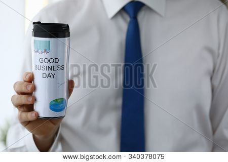 Man Hold In Hand Thermal Flask With Hot Beverage Closeup. Good Business Day With Coffee Drink Concep