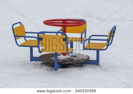 Empty Playground In Winter, Cold Weather, Low Temperature, Swing Yellow Red Blue Metal Multicolored 