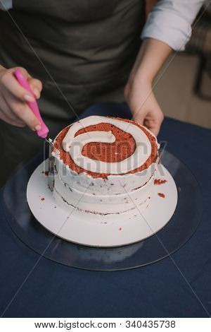 The Confectioner Levels The Cream On The Cake. The Cook Creates A Cake, Collects It And Covers It Wi