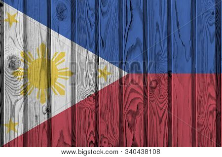 Philippines Flag Depicted In Bright Paint Colors On Old Wooden Wall. Textured Banner On Rough Backgr