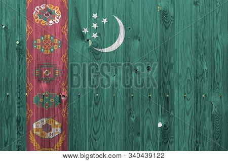 Turkmenistan Flag Depicted In Bright Paint Colors On Old Wooden Wall. Textured Banner On Rough Backg