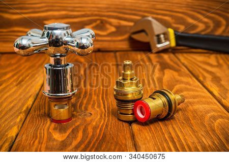 Cruciform Hot And Cold Water Main Switch Of Spare Parts On Vintage Wooden Boards