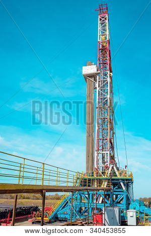 Oil And Gas Drilling Rig Onshore Dessert With Dramatic Cloudscape. Oil Drilling Rig Operation On The