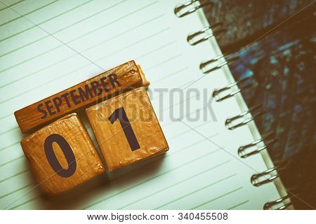 September 1st. Day 1 Of Month, Handmade Wood Cube With Date Month And Day Placed On A Lined Notebook