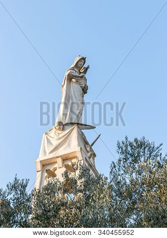 Jerusalem, Israel, December 07, 2019 : Statue Of The Mother Of God With A Baby In Her Arms On The Ro