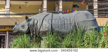 Sauraha, Nepal - November 09, 2019: Panorama Of A Rhinoceros Sculpture In Main Street Sauraha, Nepal