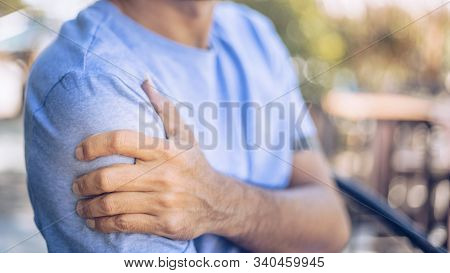 Young Man With Pain In Shoulder And Upper Arm ,health Care Concept