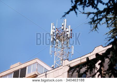 Telecommunication Base Stations Network Repeaters On The Roof Of Building. The Cellular Communicatio