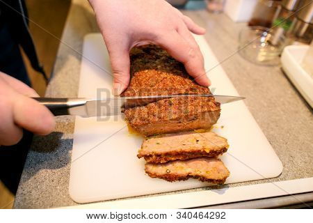 Woman Hands Cutting Piece Of Meatloaf, She Prepare For Tasting Of Food At Kitchen. Chef Cutting Meat