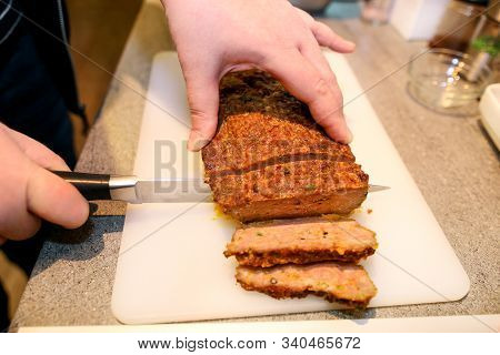 Woman Hands Cutting Piece Of Meatloaf, She Prepare For Tasting Of Food At Kitchen. Chef Cutting Meat