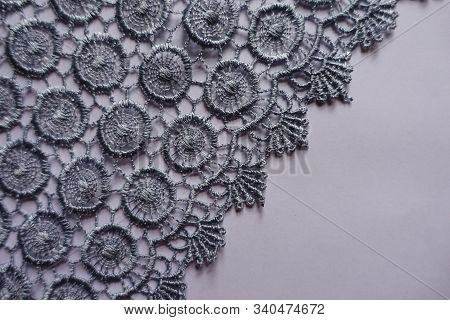 Edge Of Grey Lace Fabric On Neutral Background From Above