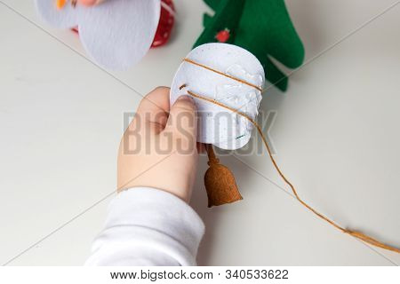The Hand Of The Child Make Snowman For Christmas Greeting Card. Xmas Toys Decoration For Greeting Ca